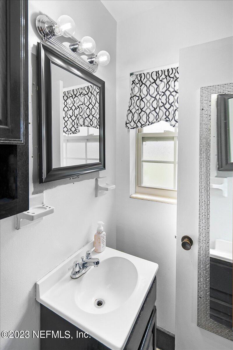 7240 Adele Court Jacksonville, FL 32277 - Photo 17 of 27 a bathroom with a sink mirror and vanity