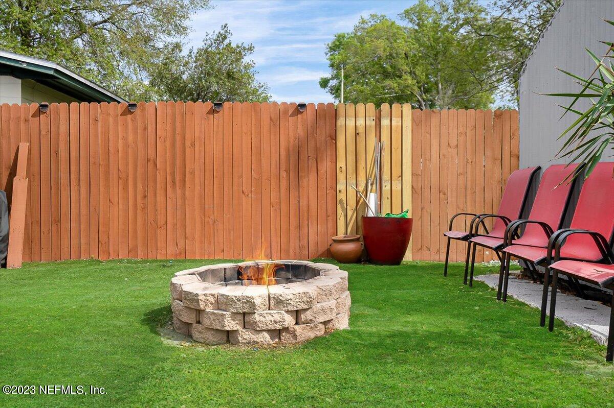 7240 Adele Court Jacksonville, FL 32277 - Photo 26 of 27 a view of a backyard with table and chairs