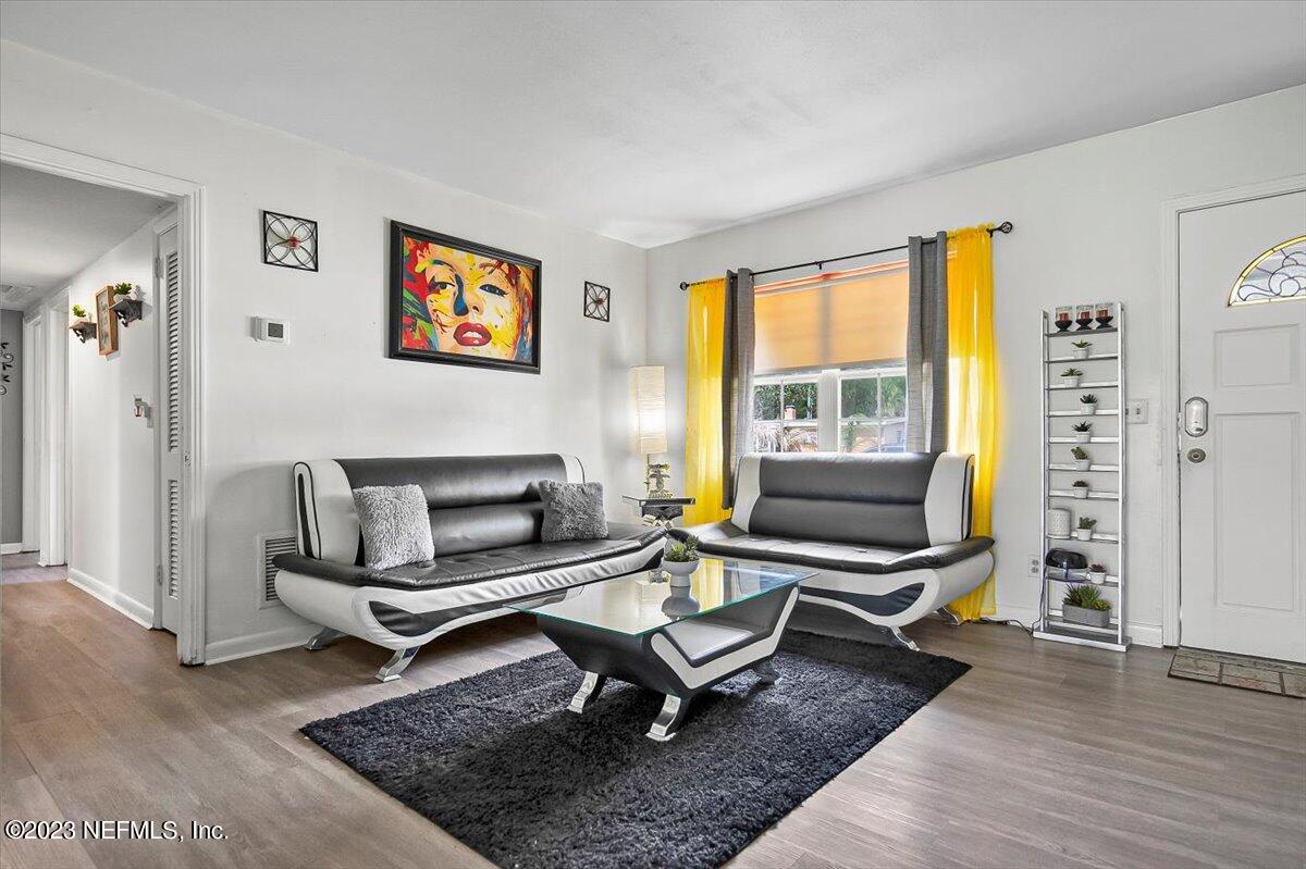 7240 Adele Court Jacksonville, FL 32277 - Photo 6 of 27 a living room with furniture a rug and a window