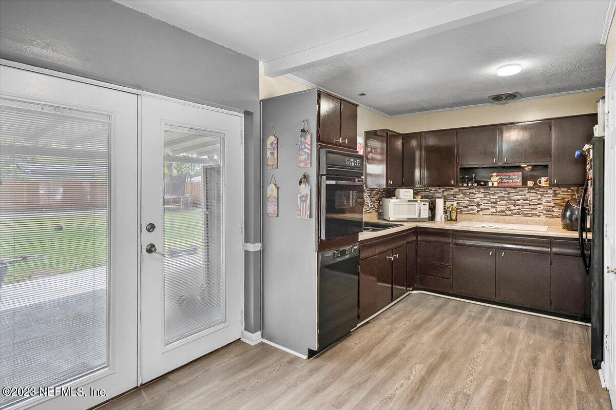 7240 Adele Court Jacksonville, FL 32277 - Photo 10 of 27 a kitchen with stainless steel appliances granite countertop a refrigerator and a sink