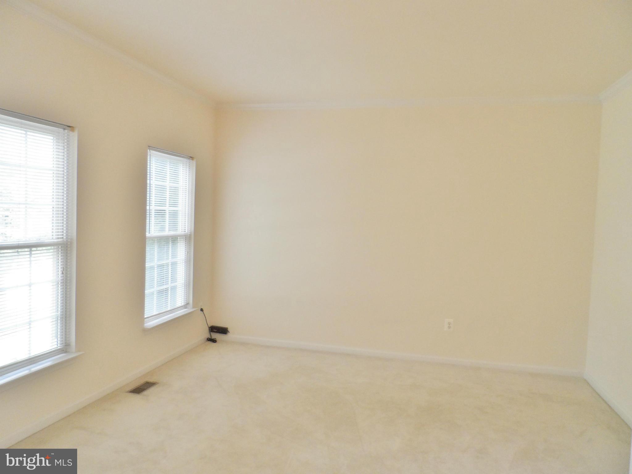 6281 Willowfield Way Springfield, VA 22150 - Photo 2 of 28 an empty room with windows