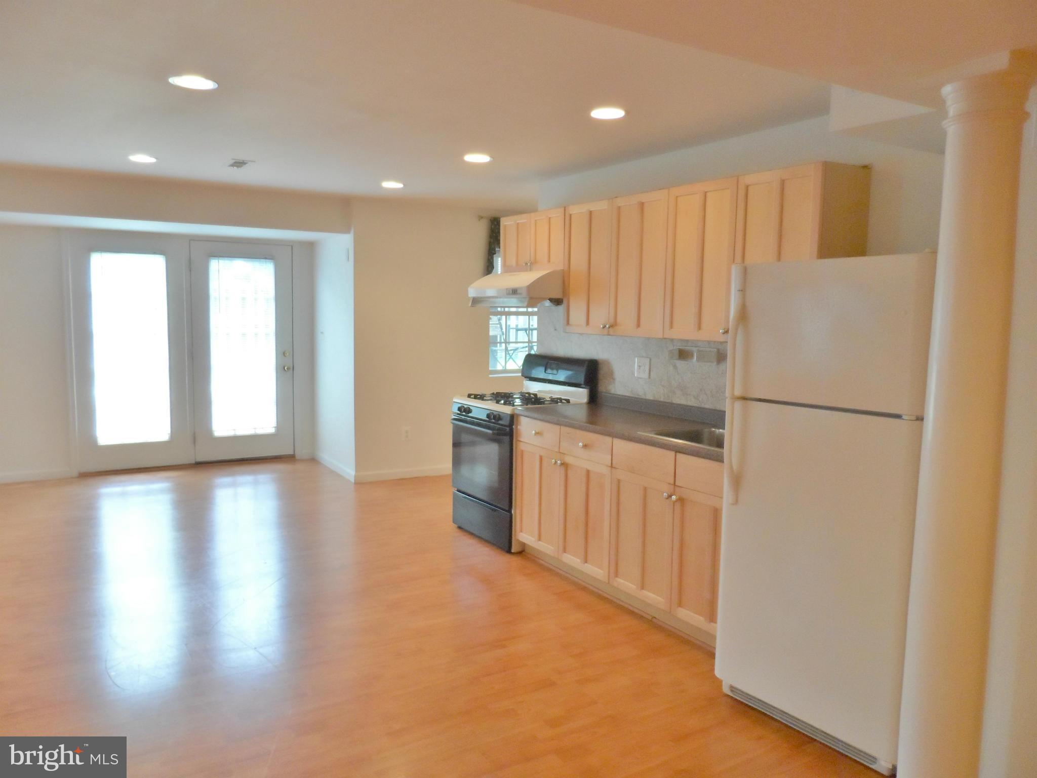 6281 Willowfield Way Springfield, VA 22150 - Photo 13 of 28 a kitchen with a refrigerator a stove top oven a sink and a counter top space