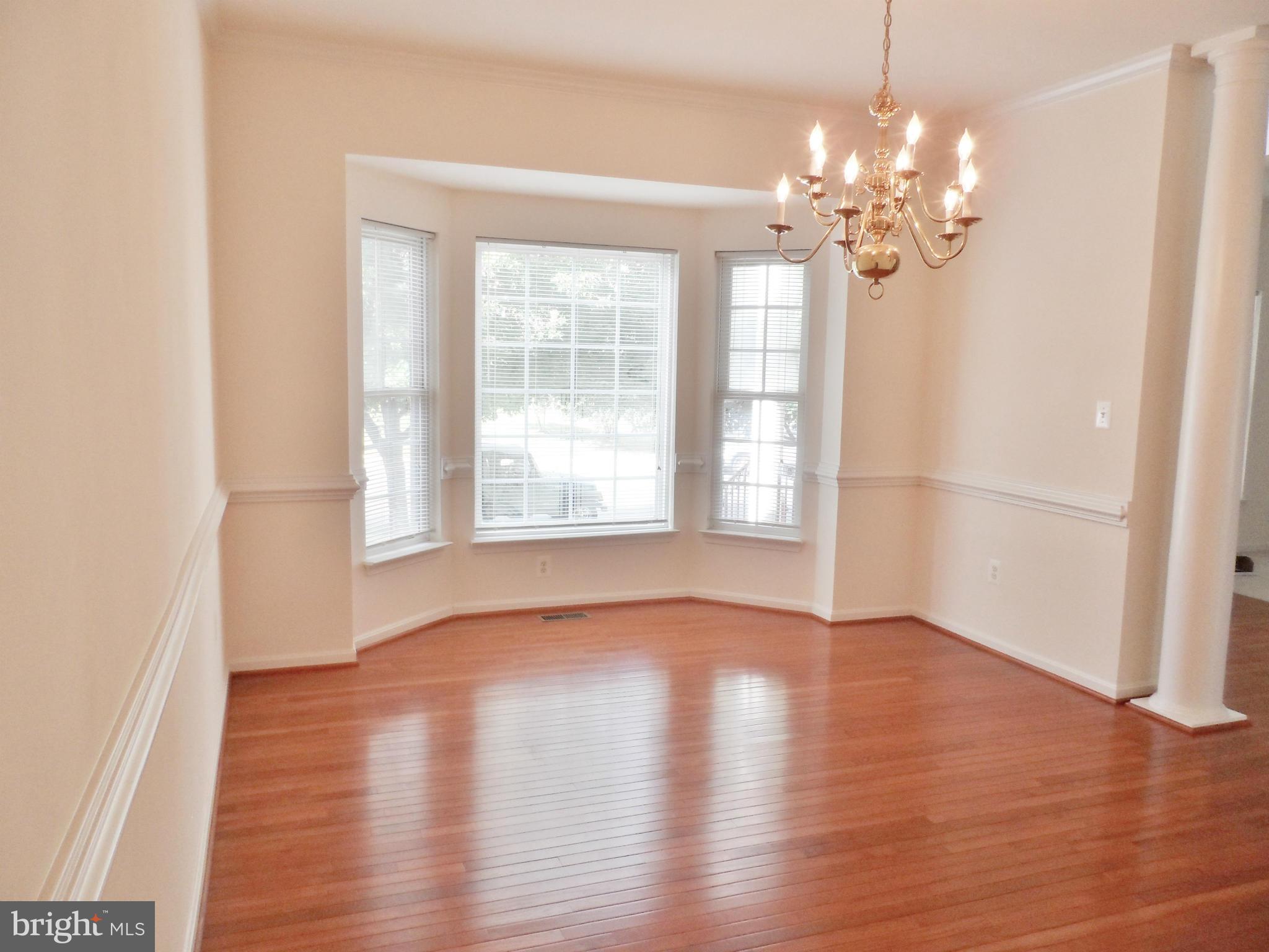 6281 Willowfield Way Springfield, VA 22150 - Photo 4 of 28 a view of an empty room with wooden floor and a window