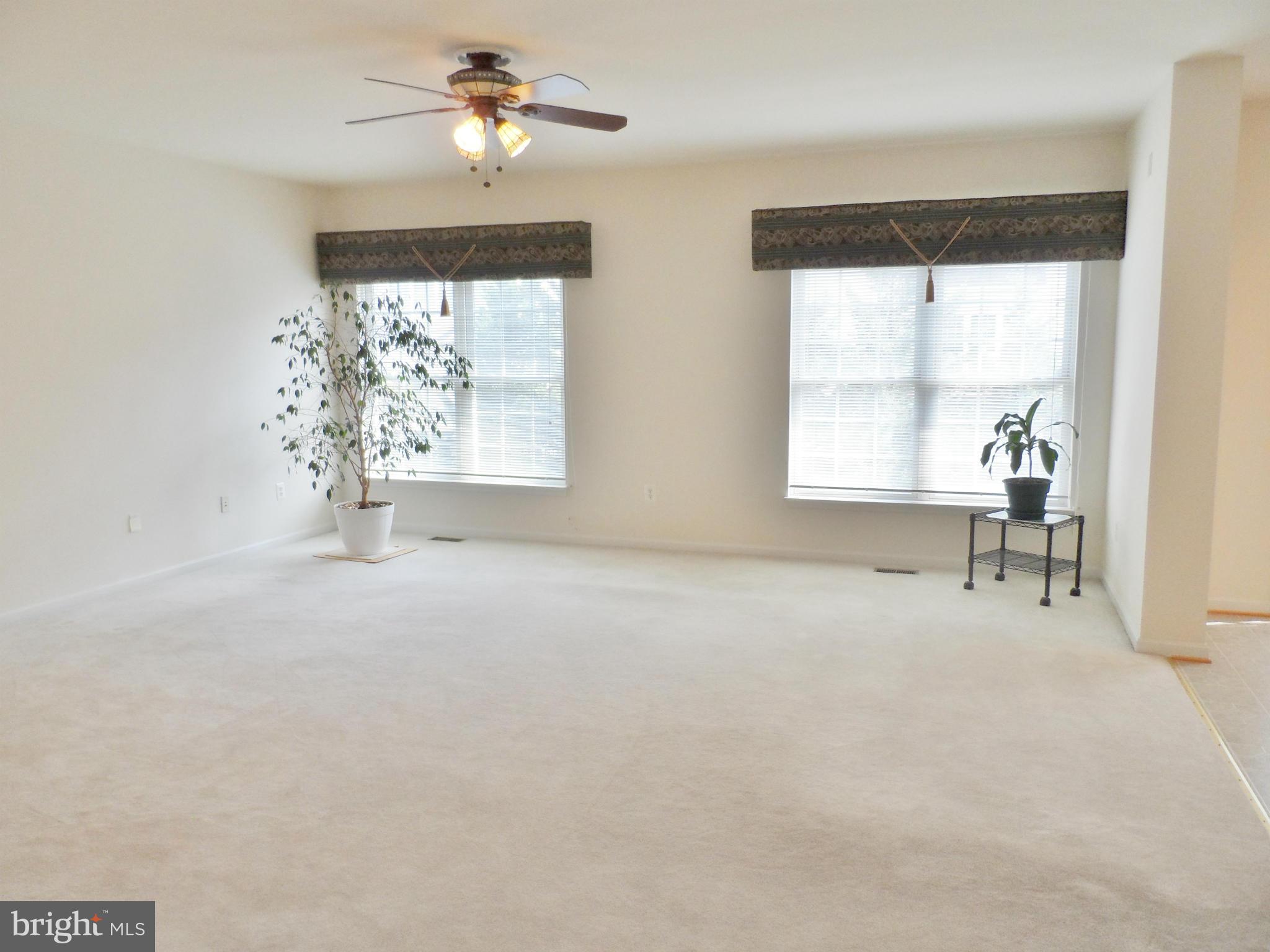 6281 Willowfield Way Springfield, VA 22150 - Photo 6 of 28 an empty room with a window and a ceiling fan