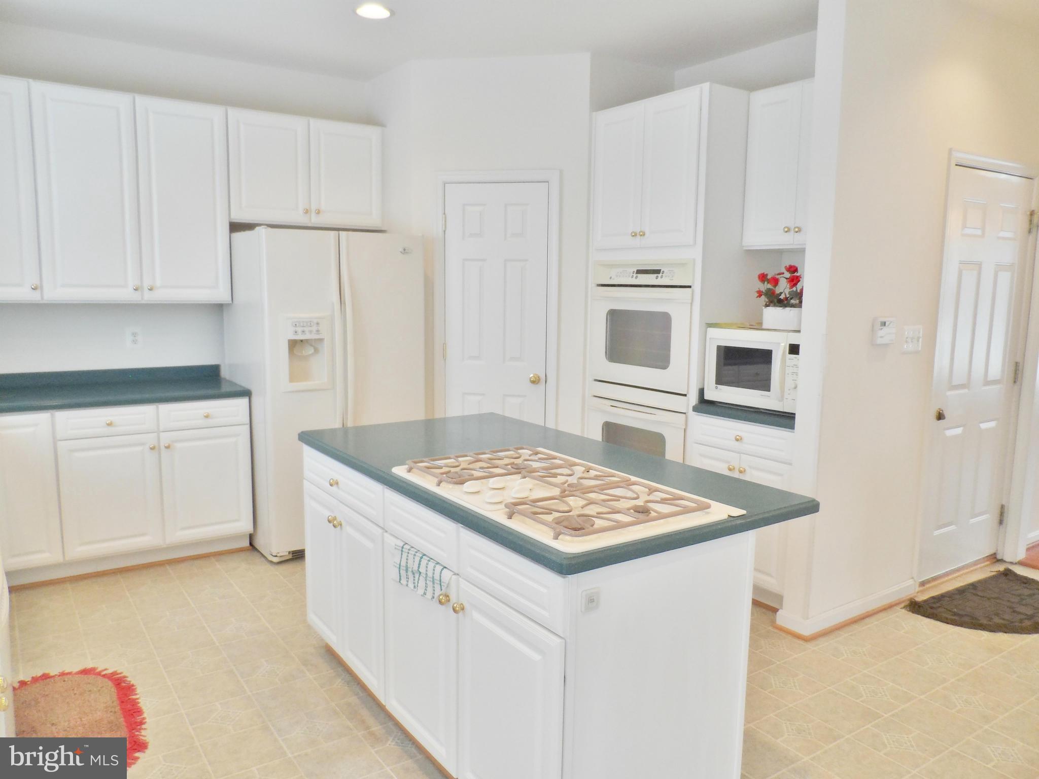 6281 Willowfield Way Springfield, VA 22150 - Photo 9 of 28 a kitchen with stainless steel appliances granite countertop a sink stove and refrigerator