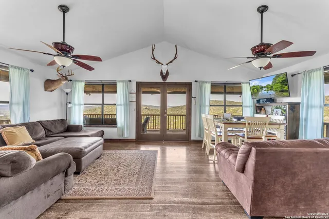 a living room with furniture a window and flat screen tv
