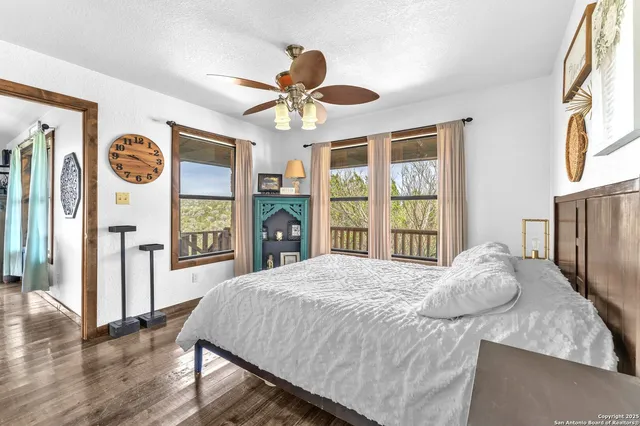 a bedroom with a bed and a large window with the outer view