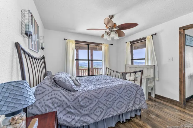 a bedroom with a bed a chandelier and dresser