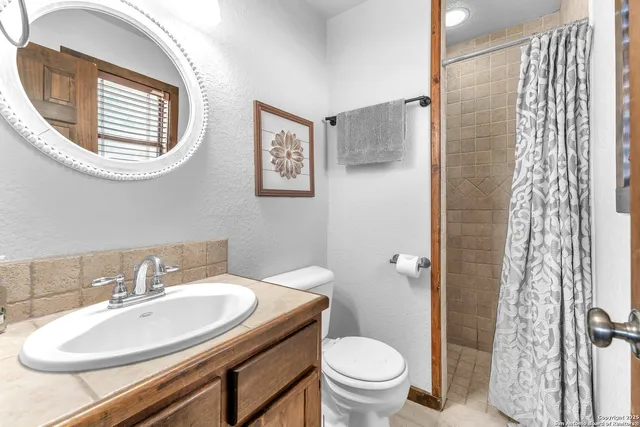 a bathroom with a sink toilet and a mirror