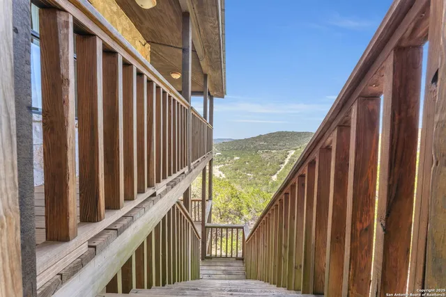 a view of balcony with wooden floor and stairs