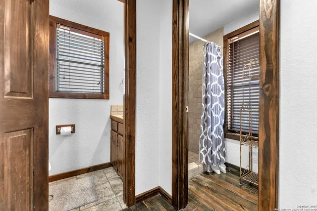 a view of a yard with wooden fence