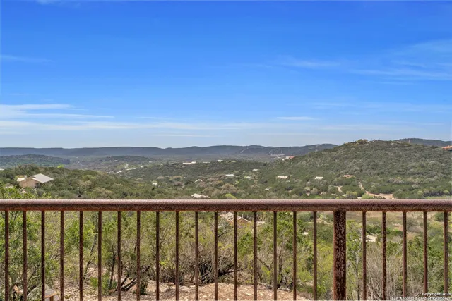 a bedroom with a bed and a table with wooden floor