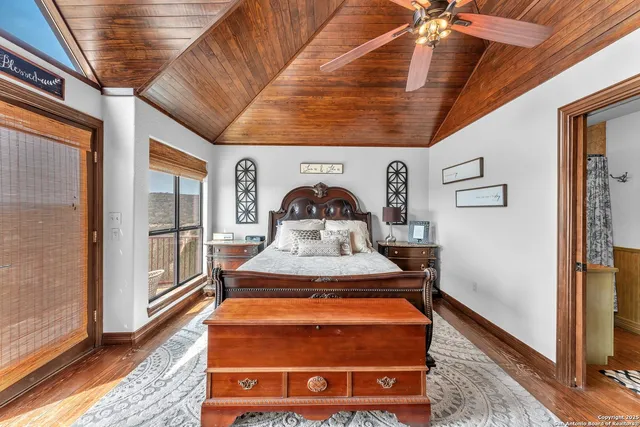 a room with a wooden floor and a kitchen