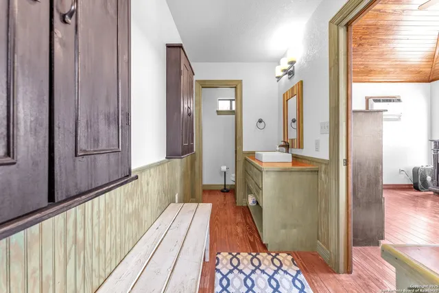 an aerial view of a house with swimming pool and trees