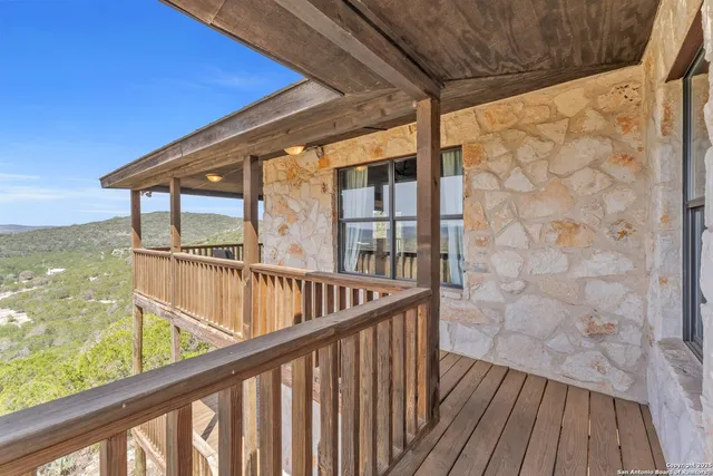 a view of balcony with wooden floor and fence