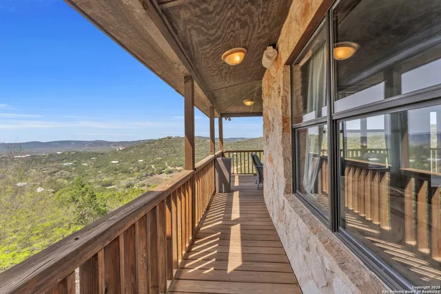 a view of a balcony with city and ocean view