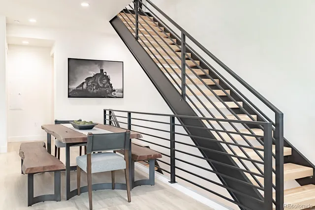 a view of a hallway with furniture and wooden floor