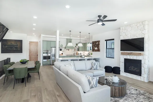 a living room with furniture a fireplace and a flat screen tv