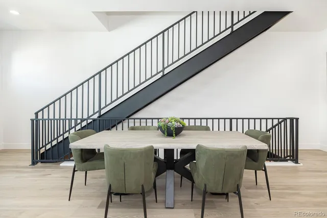 a dining room with furniture and wooden floor
