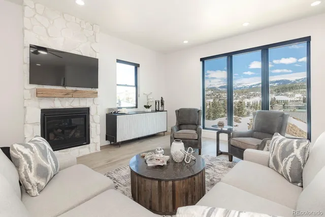 a living room with furniture fireplace and flat screen tv