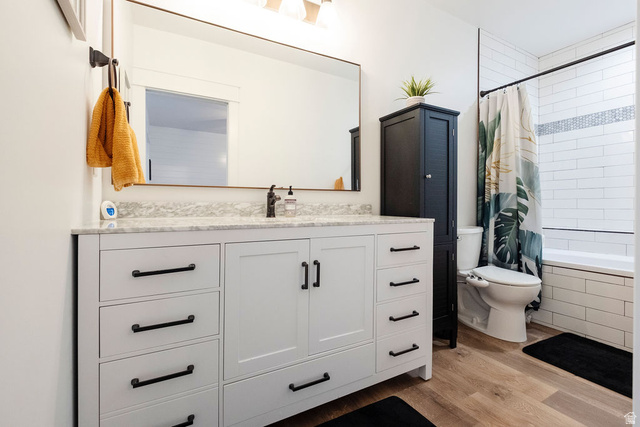 924 Country Lane Farmington, UT 84025 - Photo 56 of 91 Bathroom featuring a white vanity with a light-colored countertop, matte black hardware, and wood-finish flooring