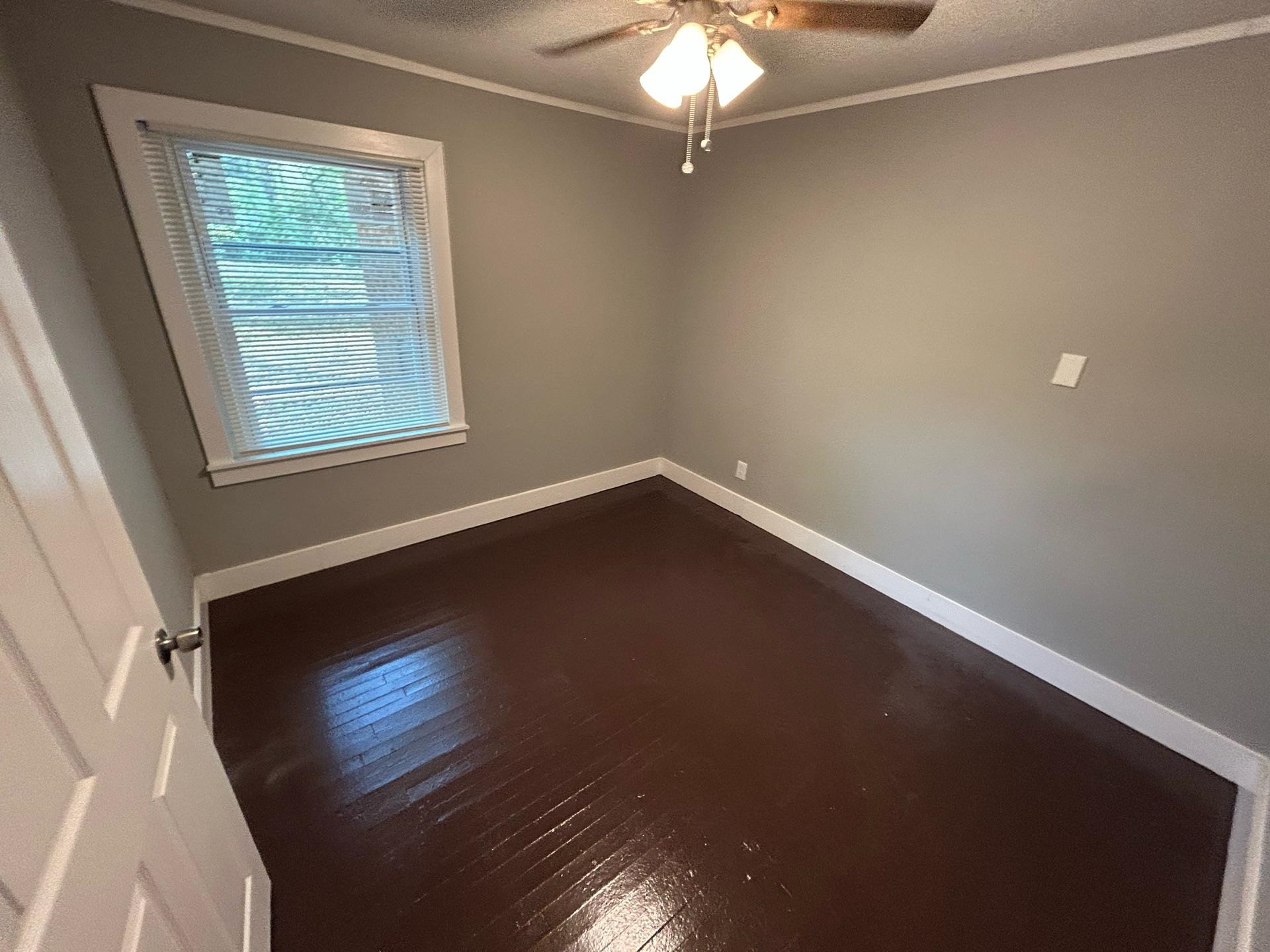 4824 Hodge Road Memphis, TN 38109 - Photo 2 of 6 Unfurnished room with dark hardwood / wood-style flooring, ceiling fan, and crown molding