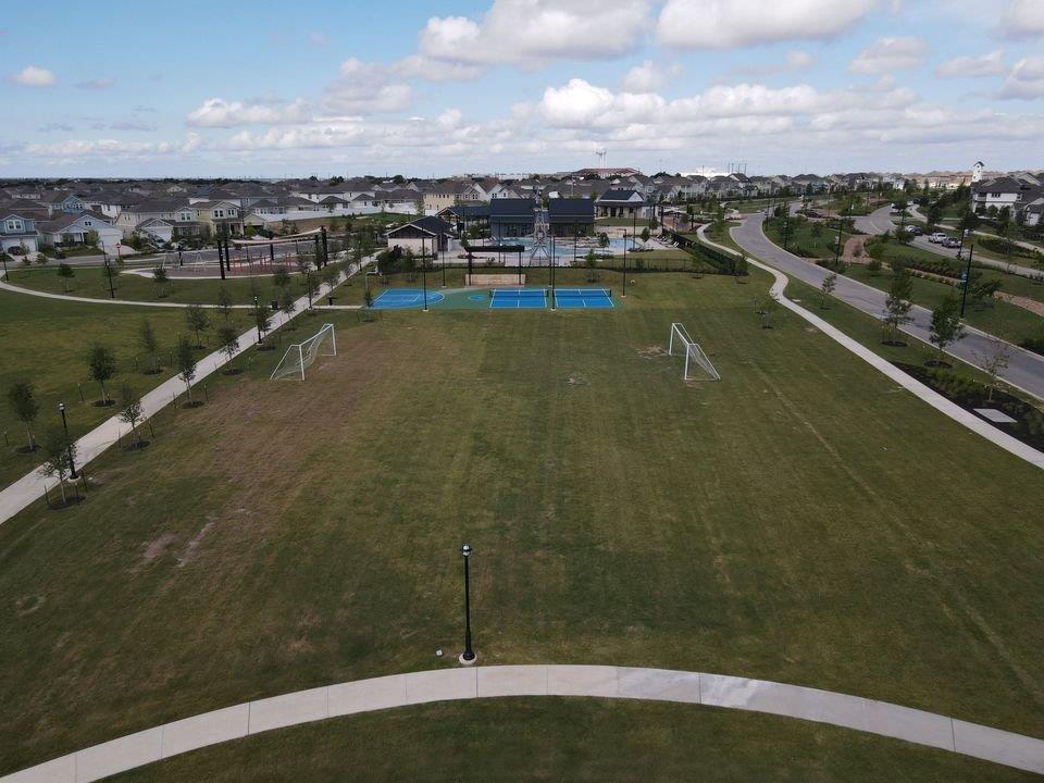 156 Huckleberry Lane Elgin, TX 78621 - Photo 12 of 16 Green spaces abound, offering soccer goals and courts for active community engagement.