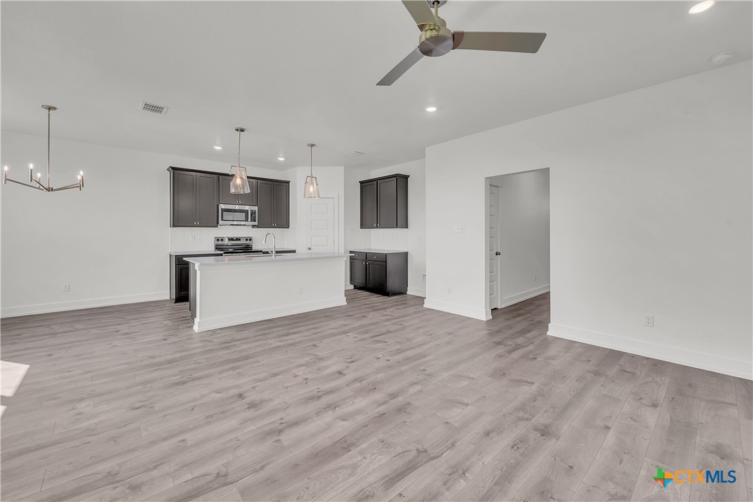 1209 Peppermint Drive Temple, TX 76501 - Photo 7 of 17 a view of a kitchen with a sink and a refrigerator