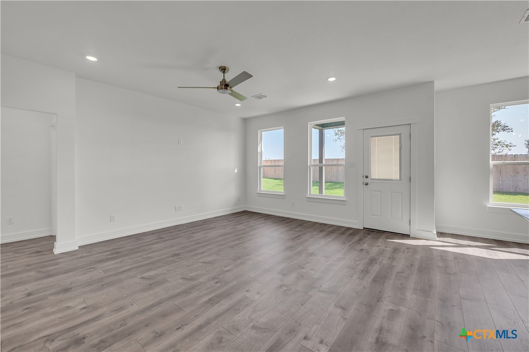 1209 Peppermint Drive Temple, TX 76501 - Photo 8 of 17 a view of an empty room with a window and wooden floor