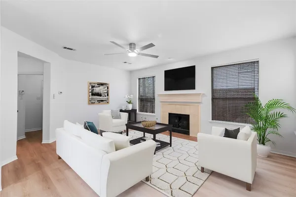 a living room with furniture a fireplace and a flat screen tv