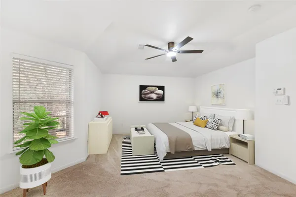 a bedroom with a bed and a potted plant