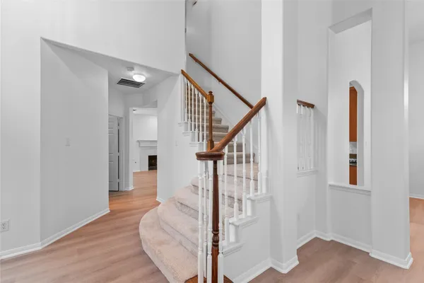 a view of entryway and hall with wooden floor