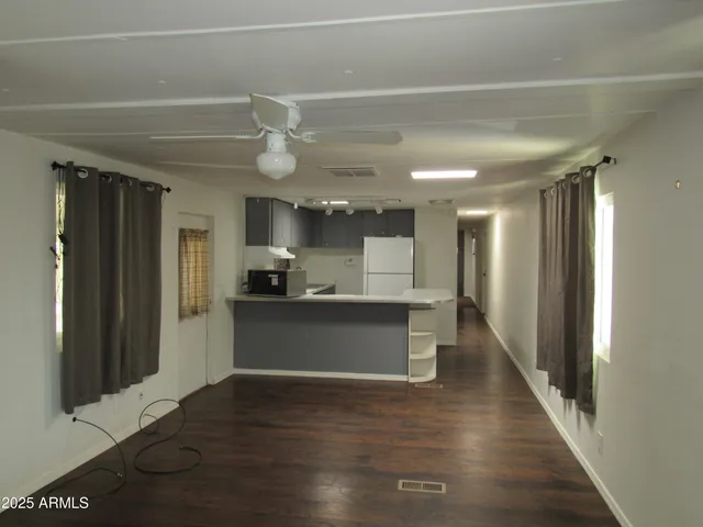 a view of a kitchen with a refrigerator and a sink