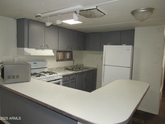 a kitchen with a refrigerator a stove a sink and a refrigerator