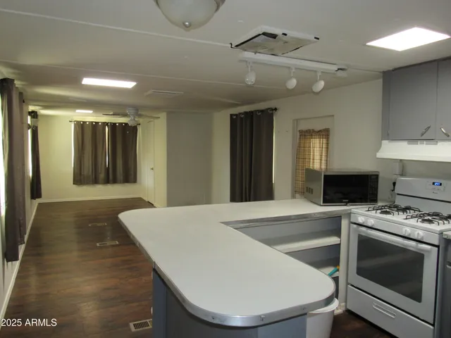 a view of kitchen with sink and microwave