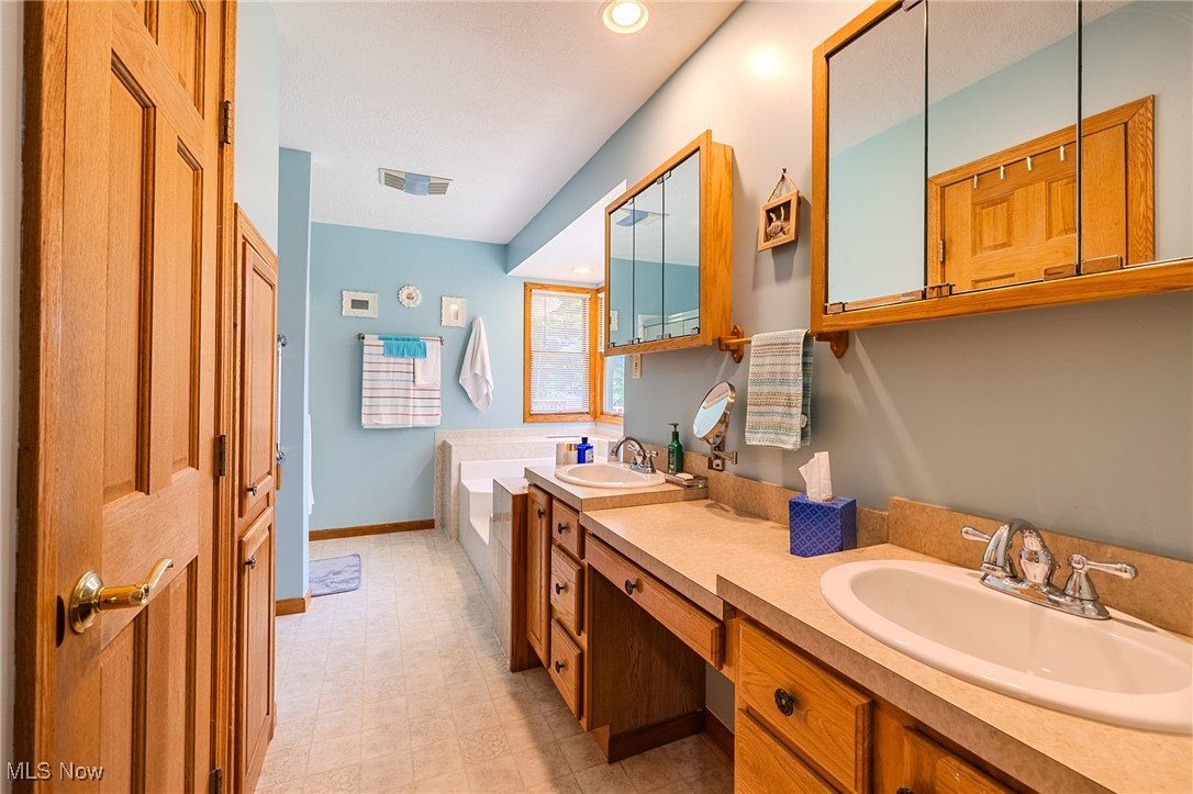 5691 Callahan Road Rome, OH 44085 - Photo 33 of 45 Bathroom featuring double vanity, recessed lighting, a garden tub, and tile patterned floors
