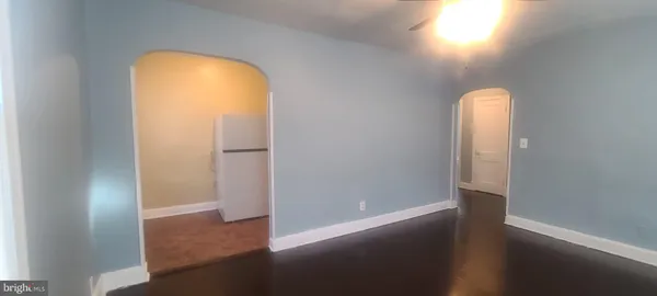 an empty room with wooden floor and a window