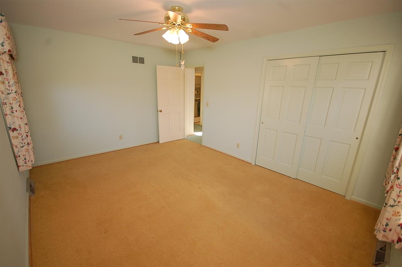 358 Cedar Grove Road Ruckersville, VA 22968 - Photo 13 of 22 an empty room with a chandelier fan and closet