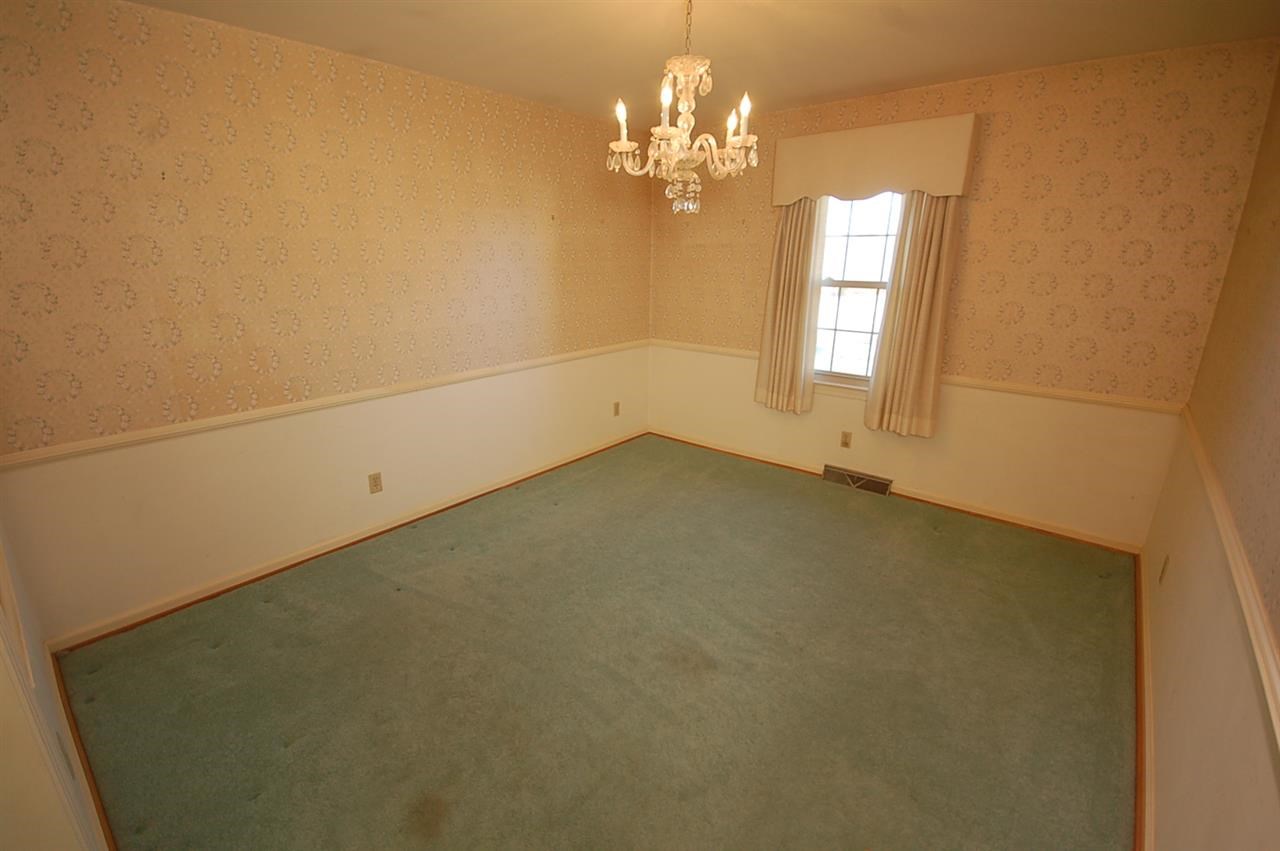 358 Cedar Grove Road Ruckersville, VA 22968 - Photo 4 of 22 en empty room with windows and chandelier