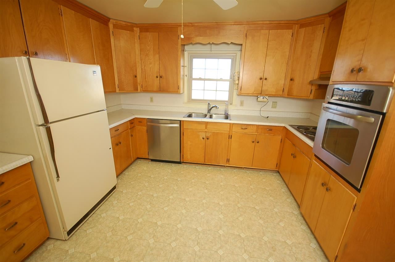 358 Cedar Grove Road Ruckersville, VA 22968 - Photo 7 of 22 a kitchen with granite countertop a refrigerator a sink a stove a microwave and island