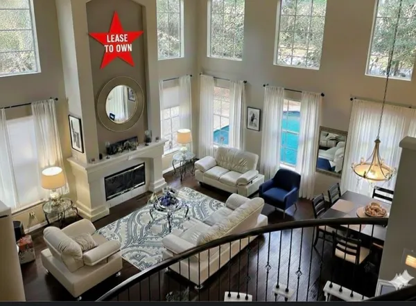 a living room with furniture a rug and a fireplace