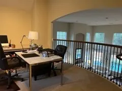 a view of a workspace with furniture