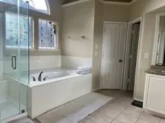 a bathroom with a bathtub and shower