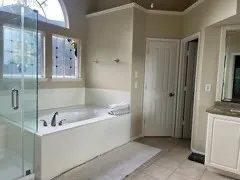 a bathroom with a bathtub sink and mirror