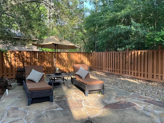 a outdoor space with patio couch and a fire pit