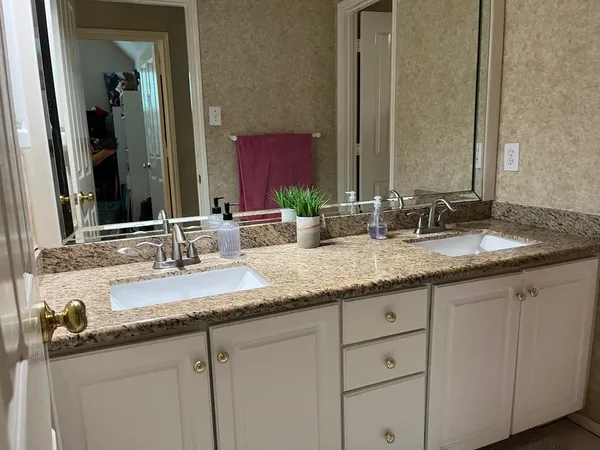 a bathroom with sinks and a mirror