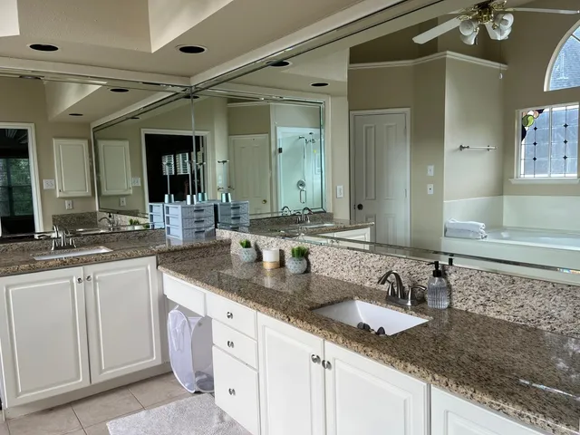 a bathroom with double sink and a mirror