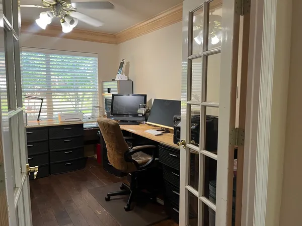 a view of a workspace with furniture and a window
