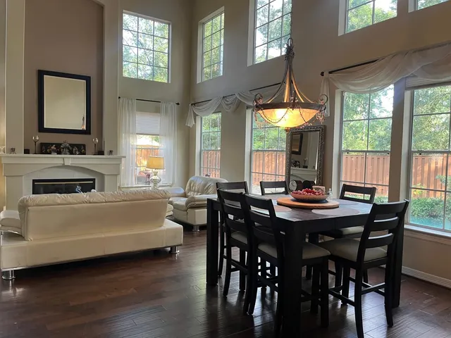 a view of a dining room and livingroom with furniture window and wooden floor