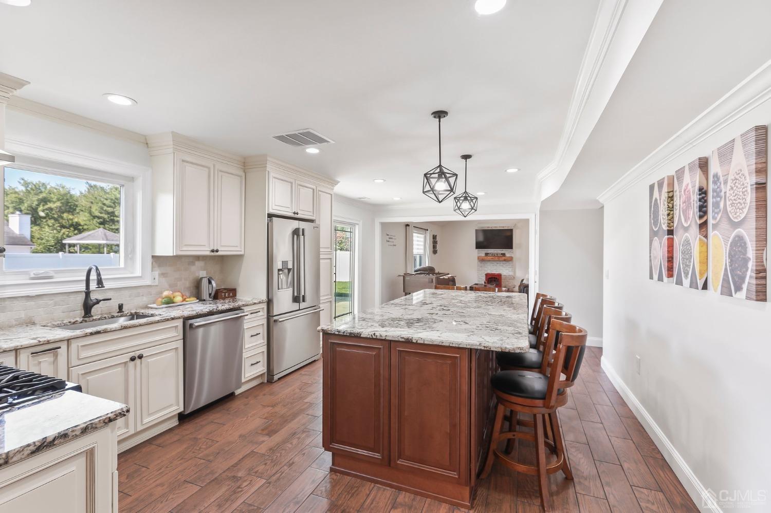 7 Mountbatten Drive Old Bridge, NJ 08857 - Photo 14 of 42 a kitchen with stainless steel appliances granite countertop wooden cabinets a stove a sink a dining table and chairs